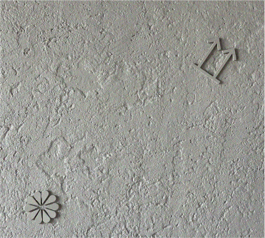 Plaster wall texture with embossed symbols