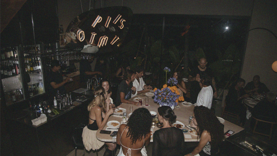 Concrete bar with candles, vinyl, marble communal table at Optimist Bali