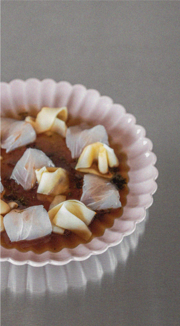 Hiramasa kingfish sashimi on a fluted pink plate at Optimist Bali